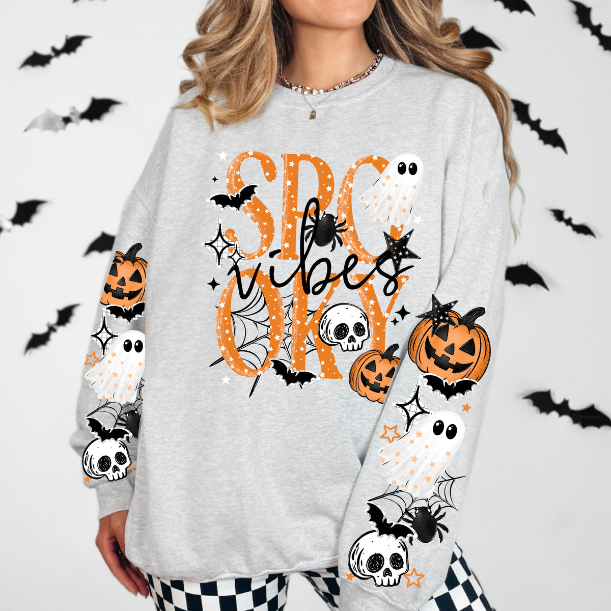 Orange Spooky Vibes sweatshirt with sleeve designs